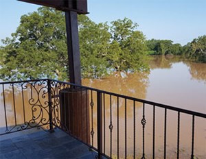 This photo was taken from the secondstory porch of Bill Head’s house, showing the backed-up water from the Brazos River after it had gone down “a foot or so.” Photo: Bill Head, Contributing Editor.