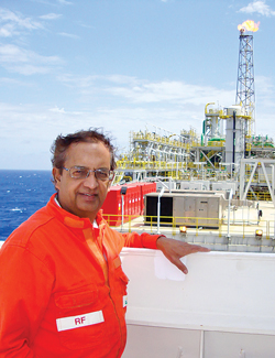 World Oil Editor Pramod Kulkarni on the wheelhouse deck of the FPSO with the flare stack in the background.
