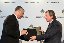 Rosneft Chairman Igor Sechin (right) hands a cooperation agreement to Sakhalin Regional Governor Alexander Khoroshavin in October 2012. Photo courtesy of Rosneft.