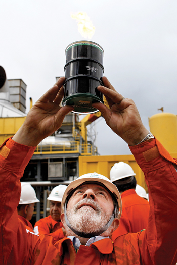 Brazilian President Luiz Inácio Lula da Silva holds up a sample of the first pre-salt oil produced at Baleia Franca Field. Courtesy of Petrobras.