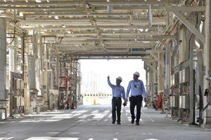 Workers at a Saudi Aramco production facility