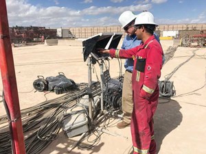 Fig. 4. Brett Chell and a field technician reviewing multiple service provider data during a frac job in the Permian basin.