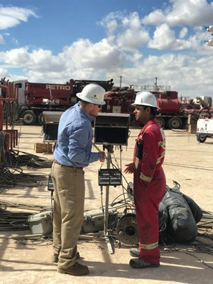 Fig. 3. Cold Bore President&#x2F;CEO Brett Chell (left) and a field engineer review service provider data and discuss water and chemical consumption during a frac job in the Permian basin.