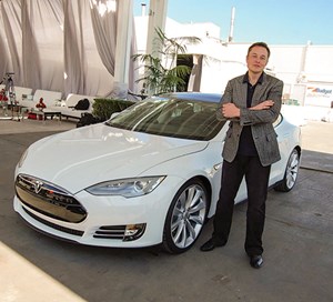 Standing next to one of his cars, Tesla Motors founder Elon Musk is a prime example of an entrepreneur and company benefiting from the public-private financing model. Photo: Tesla Motors.