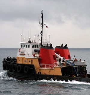 white and orange tug boat