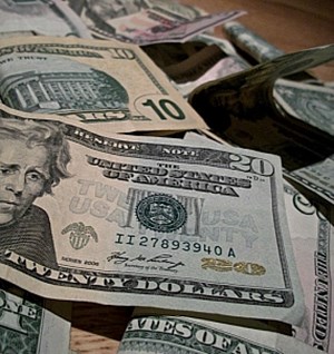 $10s and $20 dollar bills on a desk