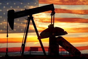 oil and gas production equipment in front of an American flag