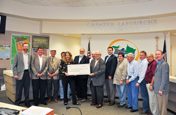 Mary Grace Anderson, development manager for Shell’s Mars deepwater field, presents a $500,000 check on March 14, 2012, to the Greater LaFourche Port Commission for its Fourchon Beach Repair and Renourishment Project.