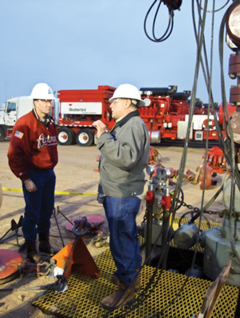 Fig. 4. Standing next to the frac stack, Swift Energy’s Chris Crawford, wellsite supervisor of the SMR JV 3H well, explains to Rep. Pete Olson (left) how the multi-stage frac job will be carried out.