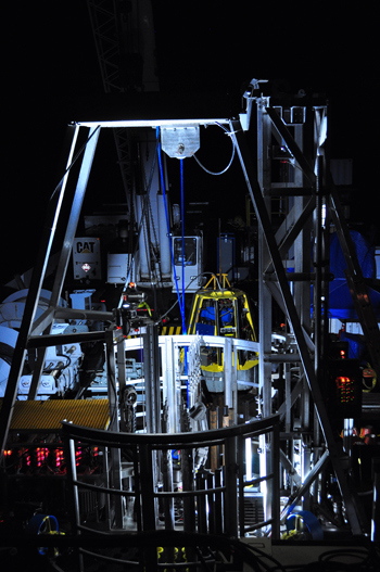 night photo of the seafloor drill in the foreground. Yellow frame in the background is the Seabed CPT unit that was also on site during the sea trials.