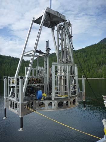photo of the seafloor drill being raised out of the water by a crane. This was taken during our sea trials off the coast of Vancouver Canada, July 2011