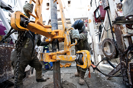 A crew works on the drill floor of a rig in Apache Canada’s House Mountain operating area.