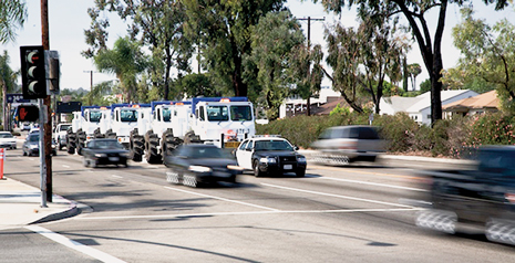 Fig. 3 Vibrator trucks proceed along Cherry Avenue with a police escort.