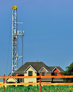 Fig. 2. The proximity of rigs to urban communities heightens the urgency to develop technologies and processes to reduce the environmental footprint. Photo courtesy of Gary Grimm.