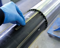 Tracer-impregnated matrix strips being inserted into a sand screen.