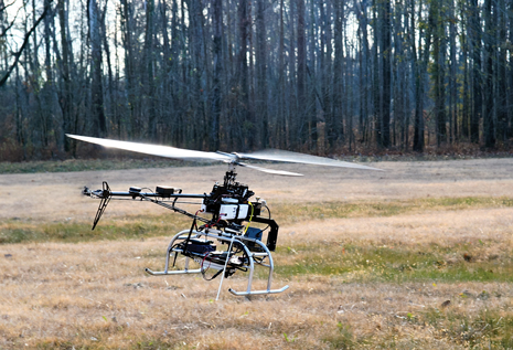 Fig. 2. A remote controlled helicopter monitors atmospheric emissions from oil and gas drilling and production operations in an NETL-funded project.