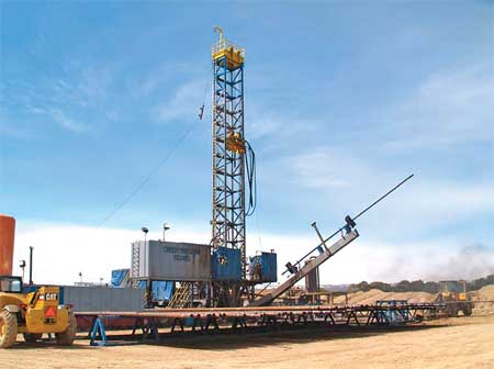 Fig. 6. The singles rig uses a pipe-handling boom arm to transfer pipe from the pipe racks to a position vertically above the hole.