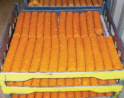 Solidified sticks of treating chemicals are designed to slowly dissolve downhole.
