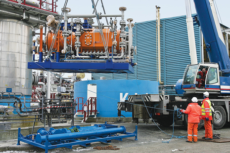 Fig. 3. Workers hoist one of Aker Solutions’ subsea gas compressors that is being tested for use on Statoil’s Åsgard field. The operator expects that through the use of compressors like this, the life of the field could be extended to 2050. Image courtesy of Statoil.